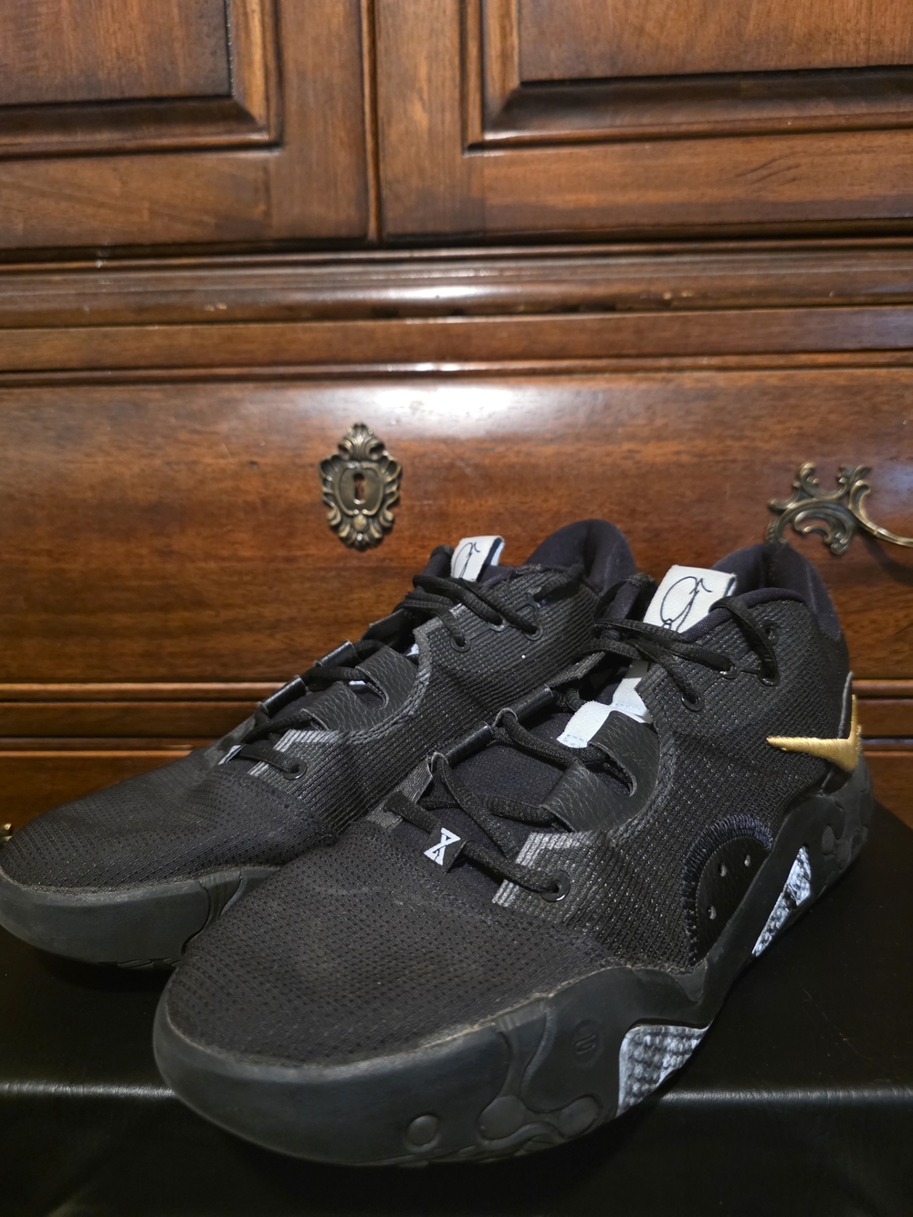 Nike Black Sneakers with Gold Swoosh